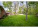 Expansive backyard showing fire pit, brickwork patio, and lush lawn perfect for outdoor activities and entertaining at 7732 Ashtree Dr, Indianapolis, IN 46259