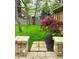 Landscaped backyard features lush lawn, mature trees, and a stone walkway to the home at 7732 Ashtree Dr, Indianapolis, IN 46259