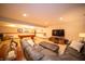 Basement recreation room features a pool table, leather couch, and large television at 7732 Ashtree Dr, Indianapolis, IN 46259
