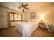 Comfortable bedroom featuring a ceiling fan, neutral decor, and a large window with natural light at 7732 Ashtree Dr, Indianapolis, IN 46259