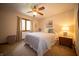Bedroom with a queen-sized bed, carpet, ceiling fan, and a window offering natural light at 7732 Ashtree Dr, Indianapolis, IN 46259