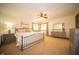 Spacious bedroom with large windows, neutral walls, a ceiling fan, and carpet floors at 7732 Ashtree Dr, Indianapolis, IN 46259