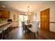 A dining area with an island, a wood table, chairs, modern cabinets, and a sliding glass door at 7732 Ashtree Dr, Indianapolis, IN 46259