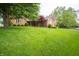 Beautiful brick home with mature trees and a well-maintained lawn at 7732 Ashtree Dr, Indianapolis, IN 46259