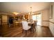 A combined kitchen and dining area featuring wood cabinets, modern appliances and an adjacent dining table at 7732 Ashtree Dr, Indianapolis, IN 46259