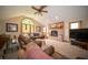 Cozy living room features a brick fireplace, leather seating, and natural light at 7732 Ashtree Dr, Indianapolis, IN 46259
