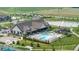 Aerial view of a community clubhouse with a pool, lake, and surrounding green spaces at 811 Harley Ln, Westfield, IN 46074