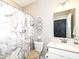 Elegant bathroom featuring a vanity with a sink, toilet, and a stylish marble-patterned shower curtain at 811 Harley Ln, Westfield, IN 46074