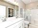 Bright bathroom features dual sinks, a large mirror, and a walk-in shower with glass doors at 811 Harley Ln, Westfield, IN 46074
