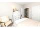 A well-lit bedroom with a cozy bed, stylish pillows, a classic dresser, and an open doorway at 811 Harley Ln, Westfield, IN 46074