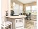 Bright breakfast nook with bar seating, a quartz counter, and a computer setup near large, sunny windows at 811 Harley Ln, Westfield, IN 46074