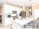 Bright kitchen featuring white cabinetry, a large island with seating, and stainless steel appliances at 811 Harley Ln, Westfield, IN 46074