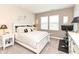 A bedroom with a white bed and furniture, with a Peloton bike in the corner at 811 Harley Ln, Westfield, IN 46074