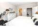 A bedroom with a white bed and furniture, with a Peloton bike in the corner at 811 Harley Ln, Westfield, IN 46074
