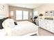 A bedroom with a white bed and furniture, with a Peloton bike in the corner at 811 Harley Ln, Westfield, IN 46074