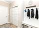 Mudroom with a built-in bench, coat hooks, and storage, enhancing organization and functionality at 811 Harley Ln, Westfield, IN 46074
