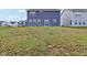 Large backyard featuring grass, exterior of home, and a sliding glass door at 8818 Tributary Dr, Indianapolis, IN 46259