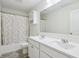 Bathroom features double sink vanity, decorative mirror, and shower with polka dot curtain at 8818 Tributary Dr, Indianapolis, IN 46259