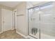Ensuite bathroom featuring walk-in shower with glass enclosure and built-in bench and linen closet at 8818 Tributary Dr, Indianapolis, IN 46259