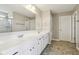 Bathroom featuring double sink vanity with granite countertops, large mirrors and shower with glass doors at 8818 Tributary Dr, Indianapolis, IN 46259