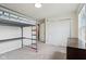 Bright bedroom features unique loft bed, neutral carpeting and a closet with double doors at 8818 Tributary Dr, Indianapolis, IN 46259