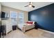 Bedroom with modern design, a stylish navy accent wall, and ample natural light at 8818 Tributary Dr, Indianapolis, IN 46259