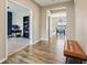 Well-lit hallway showcases hardwood floors and views of an office space and an inviting dining room at 8818 Tributary Dr, Indianapolis, IN 46259