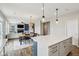 Open concept living and kitchen area with fireplace, stairs and large white sofa at 8818 Tributary Dr, Indianapolis, IN 46259