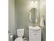 Compact powder room with modern fixtures, vanity, toilet, and fresh paint at 8818 Tributary Dr, Indianapolis, IN 46259