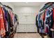 Spacious walk-in closet with plenty of storage with white shelving, drawers and carpeted floor at 8818 Tributary Dr, Indianapolis, IN 46259