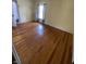 Bright bedroom featuring hardwood floors, a large window, and natural light at 925 E Main St, Muncie, IN 47305