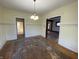 Spacious dining room featuring paneled walls, hardwood floors, and decorative lighting fixture at 925 E Main St, Muncie, IN 47305