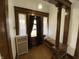 Charming foyer with hardwood floors, natural woodwork, and a cozy bench at 925 E Main St, Muncie, IN 47305