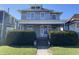 Charming gray two-story home with a covered porch and well-manicured landscaping at 925 E Main St, Muncie, IN 47305