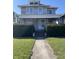 Classic two-story home with a cozy front porch, mature landscaping, and a well-maintained lawn at 925 E Main St, Muncie, IN 47305