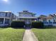 Attractive two-story home featuring a welcoming front porch and lush green lawn at 925 E Main St, Muncie, IN 47305