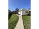 Detached white one-car garage in a fenced backyard with a walkway leading to the entrance at 925 E Main St, Muncie, IN 47305