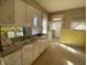 Charming kitchen featuring classic cabinets, tiled backsplash, and vintage-style fixtures at 925 E Main St, Muncie, IN 47305