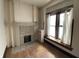 Bright room with fireplace, hardwood floors and a sun-filled window seat at 925 E Main St, Muncie, IN 47305