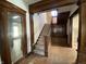 Grand staircase featuring wood accents, carpet steps, and paneled walls at 925 E Main St, Muncie, IN 47305