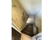 Worn staircase going down from a hallway or entry with peeling paint and weathered features needing renovation at 925 E Main St, Muncie, IN 47305