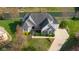 Stunning aerial view of a luxurious home with lush landscaping, a private dock, and waterfront access at 999 Box Turtle Ct, Columbus, IN 47201