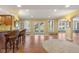 Spacious basement with bar-style seating and doors leading to the outdoors, filled with natural light at 999 Box Turtle Ct, Columbus, IN 47201
