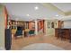 Finished basement with a bar area, built-in shelving, and seating with views into another room at 999 Box Turtle Ct, Columbus, IN 47201