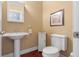 Small, stylish bathroom with pedestal sink and modern fixtures at 999 Box Turtle Ct, Columbus, IN 47201