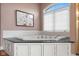 A close up shot of a relaxing soaking tub with black marble countertop in bathroom at 999 Box Turtle Ct, Columbus, IN 47201