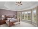 This spacious primary bedroom features tray ceilings, a seating area and large windows at 999 Box Turtle Ct, Columbus, IN 47201