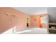 Bright bedroom with peach-colored walls, shelving, and view into an en-suite bathroom at 999 Box Turtle Ct, Columbus, IN 47201