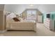 Well-lit bedroom featuring a neutral color palette and furnishings, including a white bed, dresser, and desk area at 999 Box Turtle Ct, Columbus, IN 47201