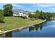 Scenic view of an upscale waterfront home with a well-manicured lawn reflecting in the water at 999 Box Turtle Ct, Columbus, IN 47201